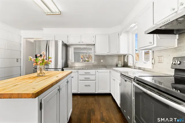 a kitchen with granite countertop a sink and cabinets
