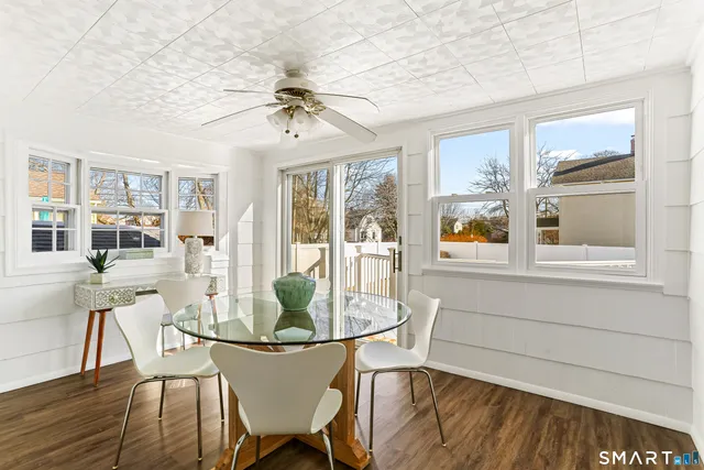 a dining room with furniture a chandelier and wooden floor