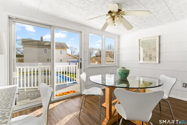a dining room with furniture a chandelier and wooden floor