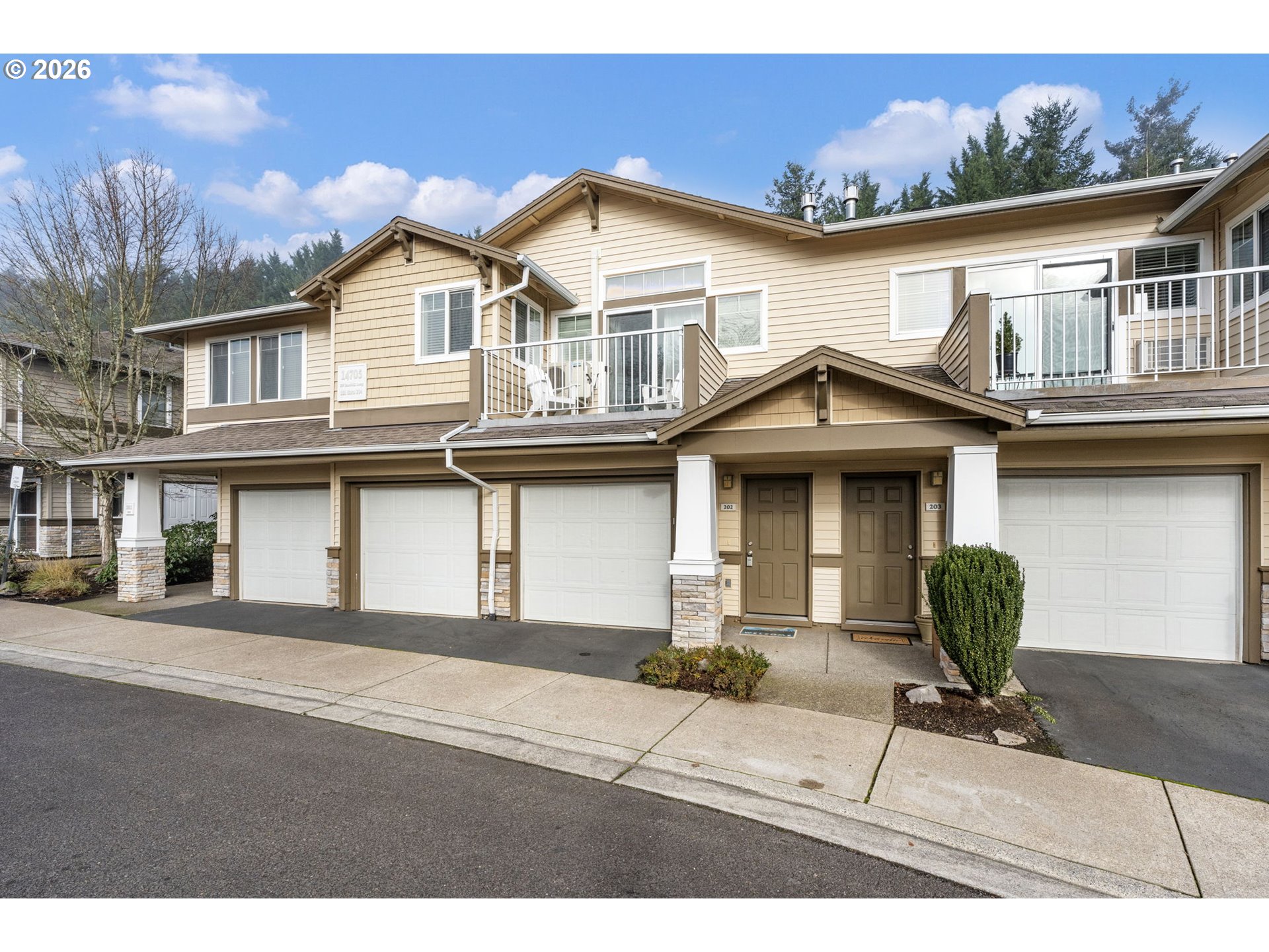 14705 Southwest Sandhill Loop, Unit 202 Beaverton, OR 97007 - Photo 1 of 24 a front view of a house with a yard and garage