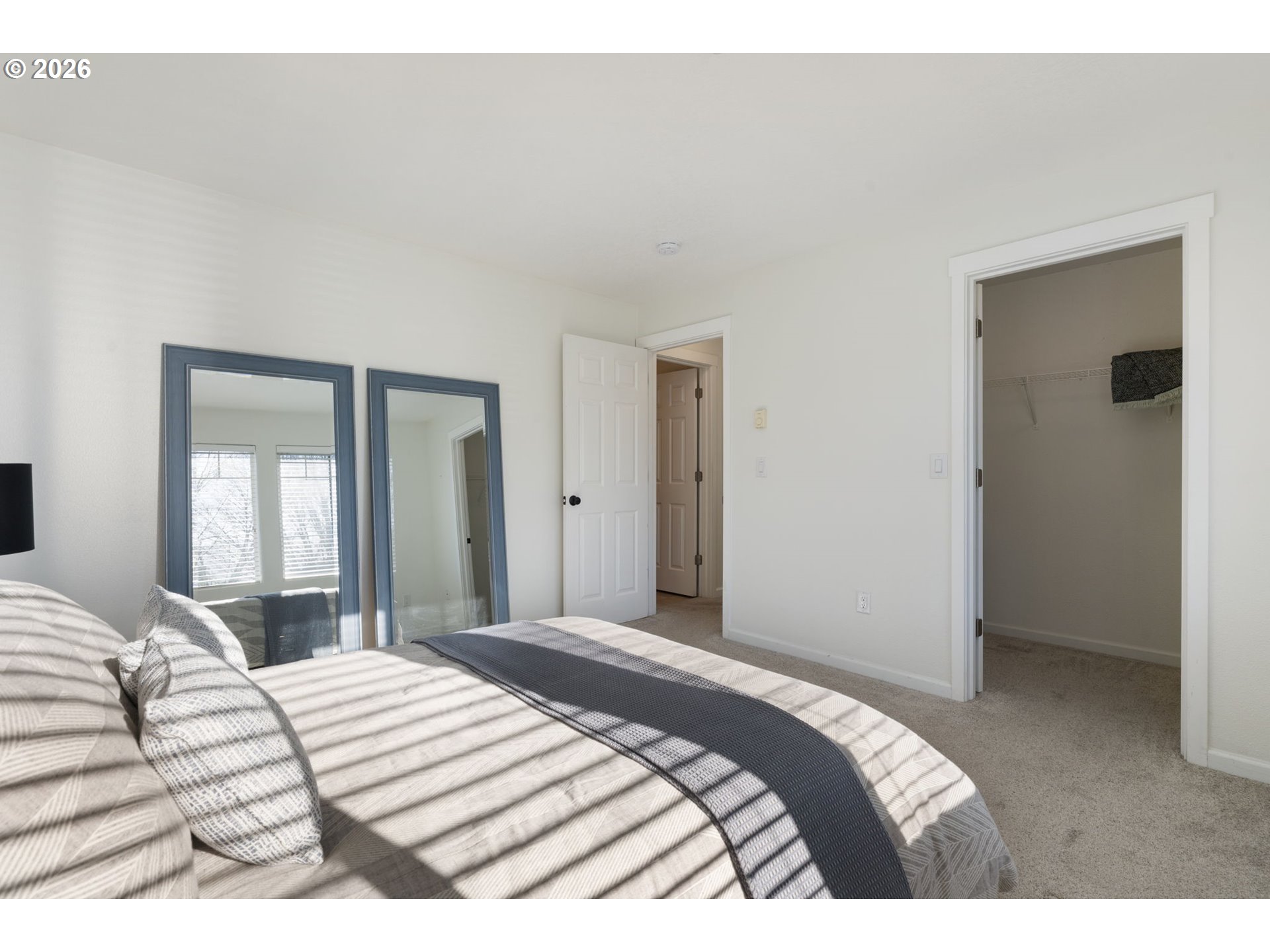 14705 Southwest Sandhill Loop, Unit 202 Beaverton, OR 97007 - Photo 11 of 24 a bedroom with a bed and a mirror