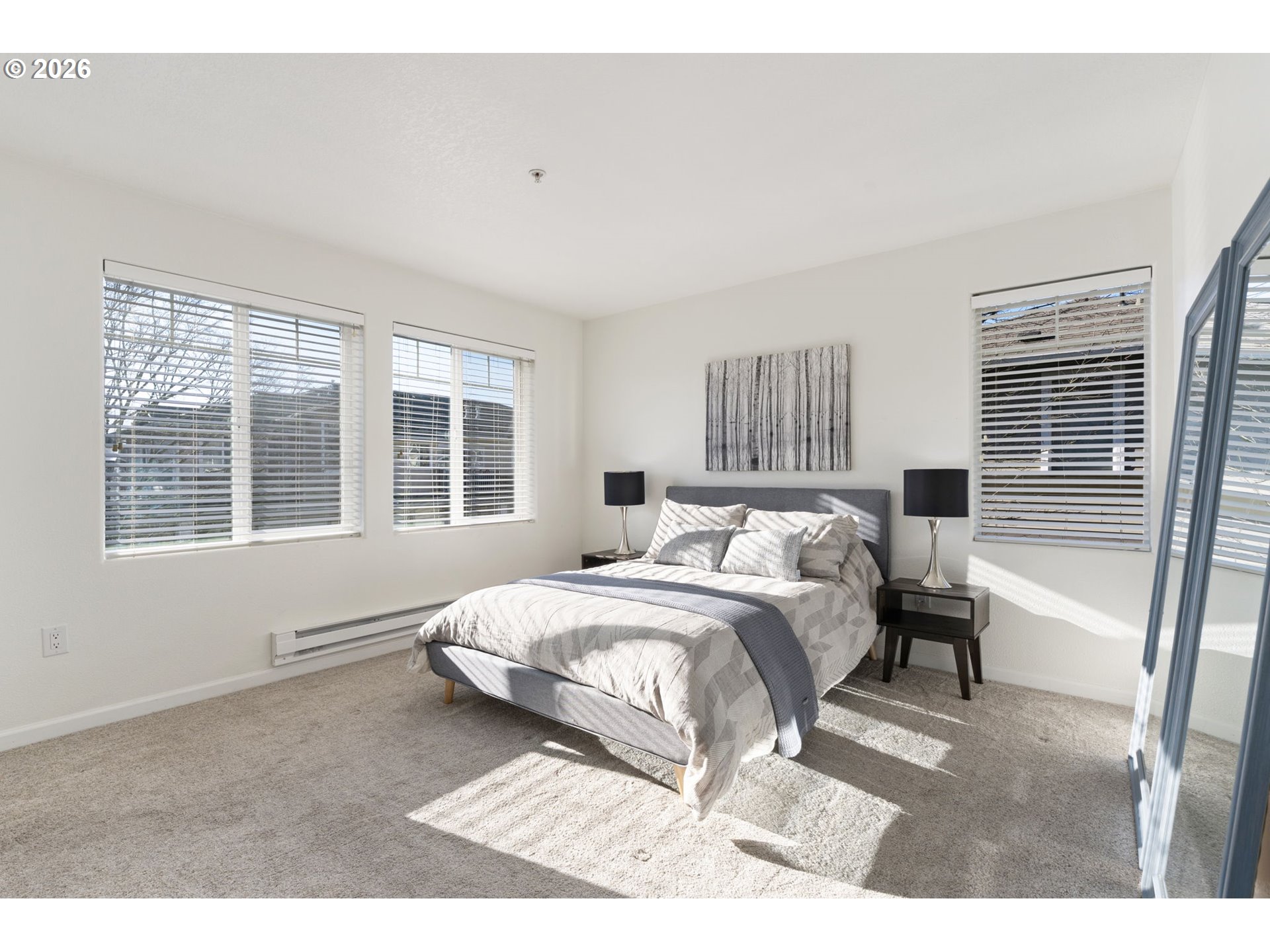 14705 Southwest Sandhill Loop, Unit 202 Beaverton, OR 97007 - Photo 12 of 24 a bedroom with a bed and a large window