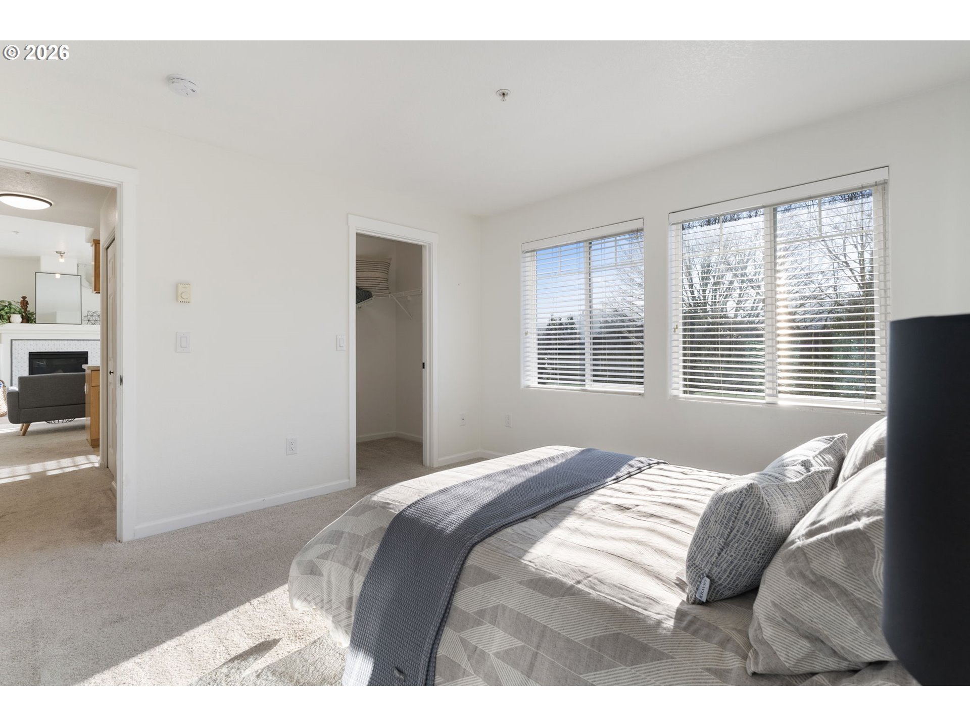 14705 Southwest Sandhill Loop, Unit 202 Beaverton, OR 97007 - Photo 13 of 24 a bedroom with a bed and a large window