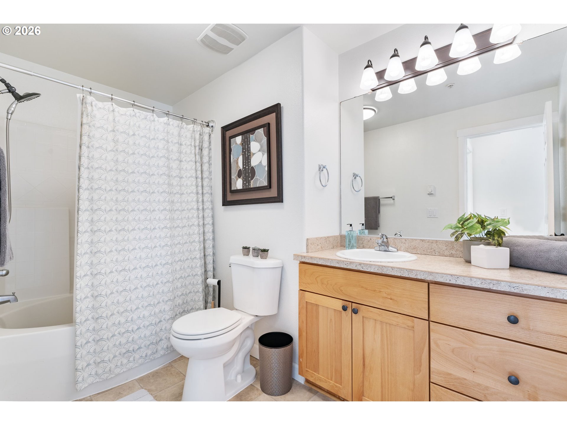 14705 Southwest Sandhill Loop, Unit 202 Beaverton, OR 97007 - Photo 15 of 24 a bathroom with a toilet a sink and mirror