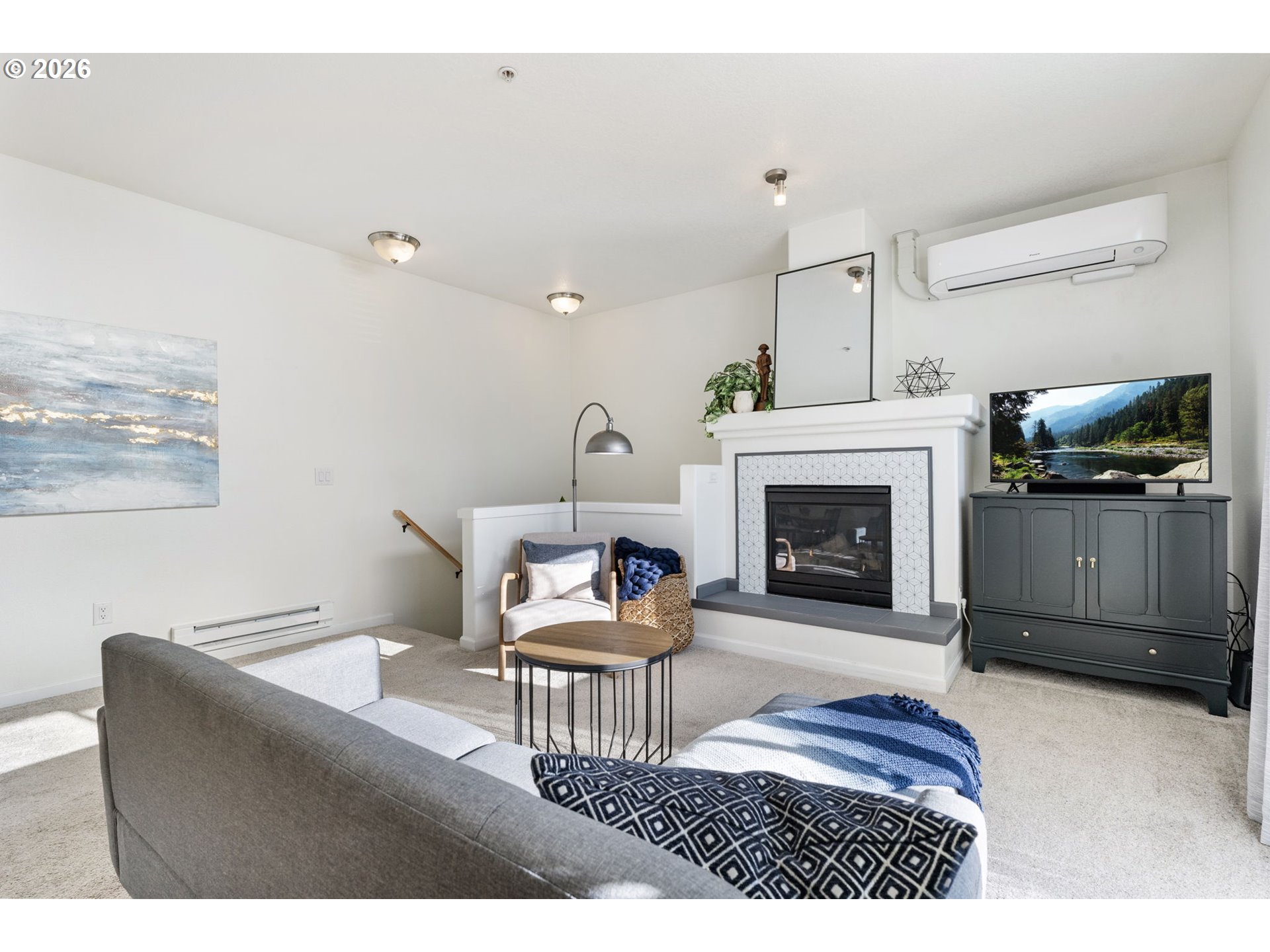 14705 Southwest Sandhill Loop, Unit 202 Beaverton, OR 97007 - Photo 21 of 24 a living room with furniture a flat screen tv and a fireplace
