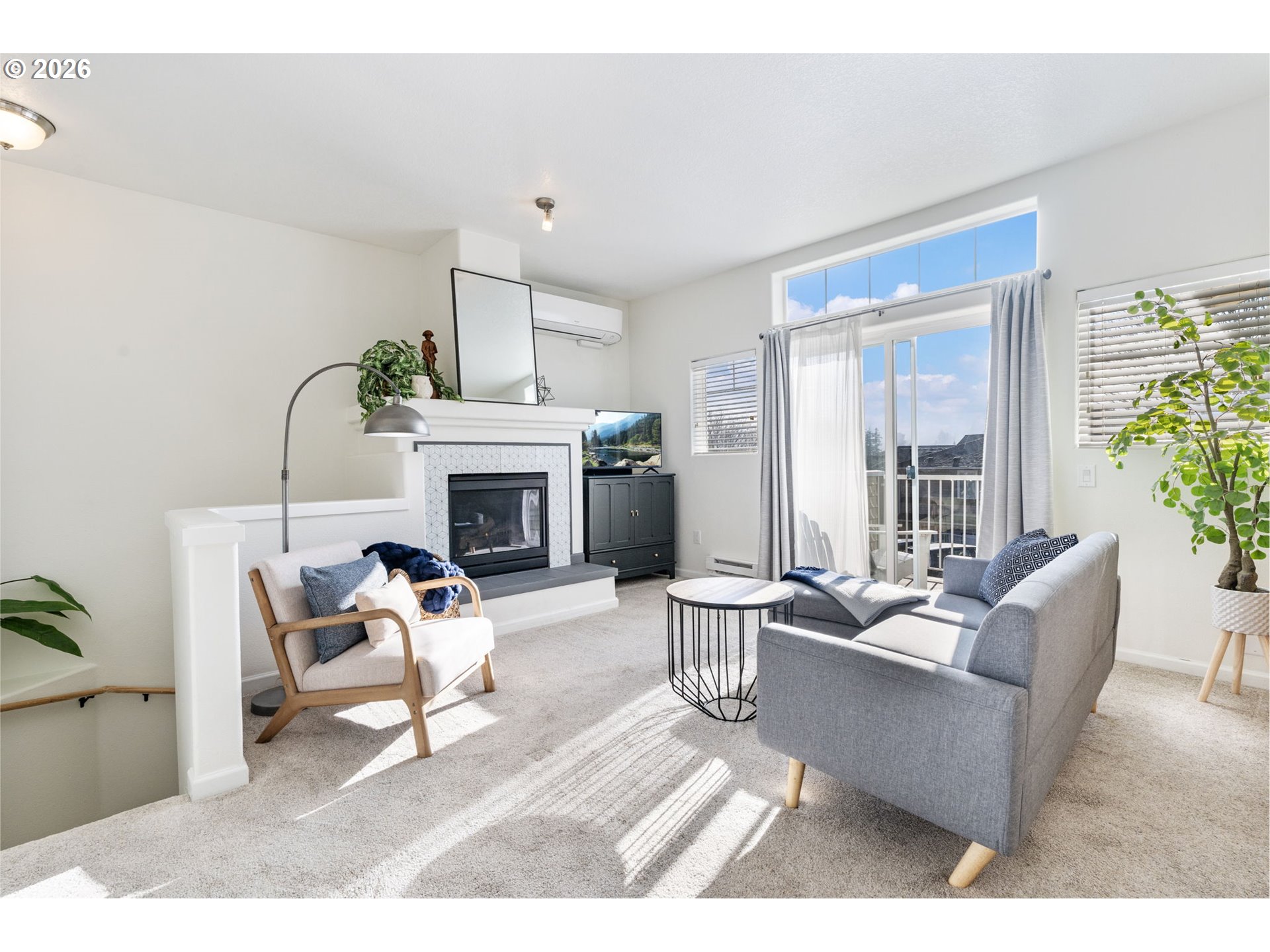 14705 Southwest Sandhill Loop, Unit 202 Beaverton, OR 97007 - Photo 5 of 24 a living room with furniture a fireplace and a potted plant