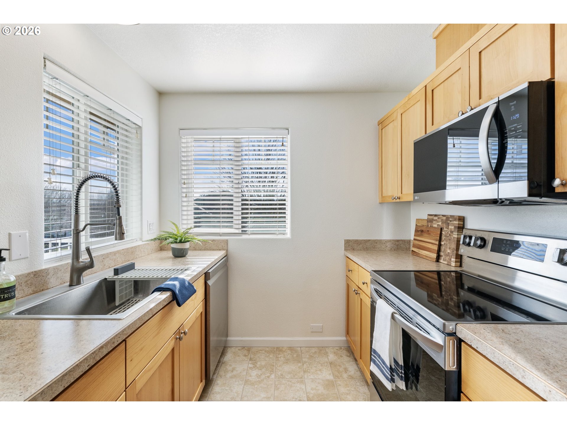 14705 Southwest Sandhill Loop, Unit 202 Beaverton, OR 97007 - Photo 8 of 24 a kitchen that has a sink and a stove
