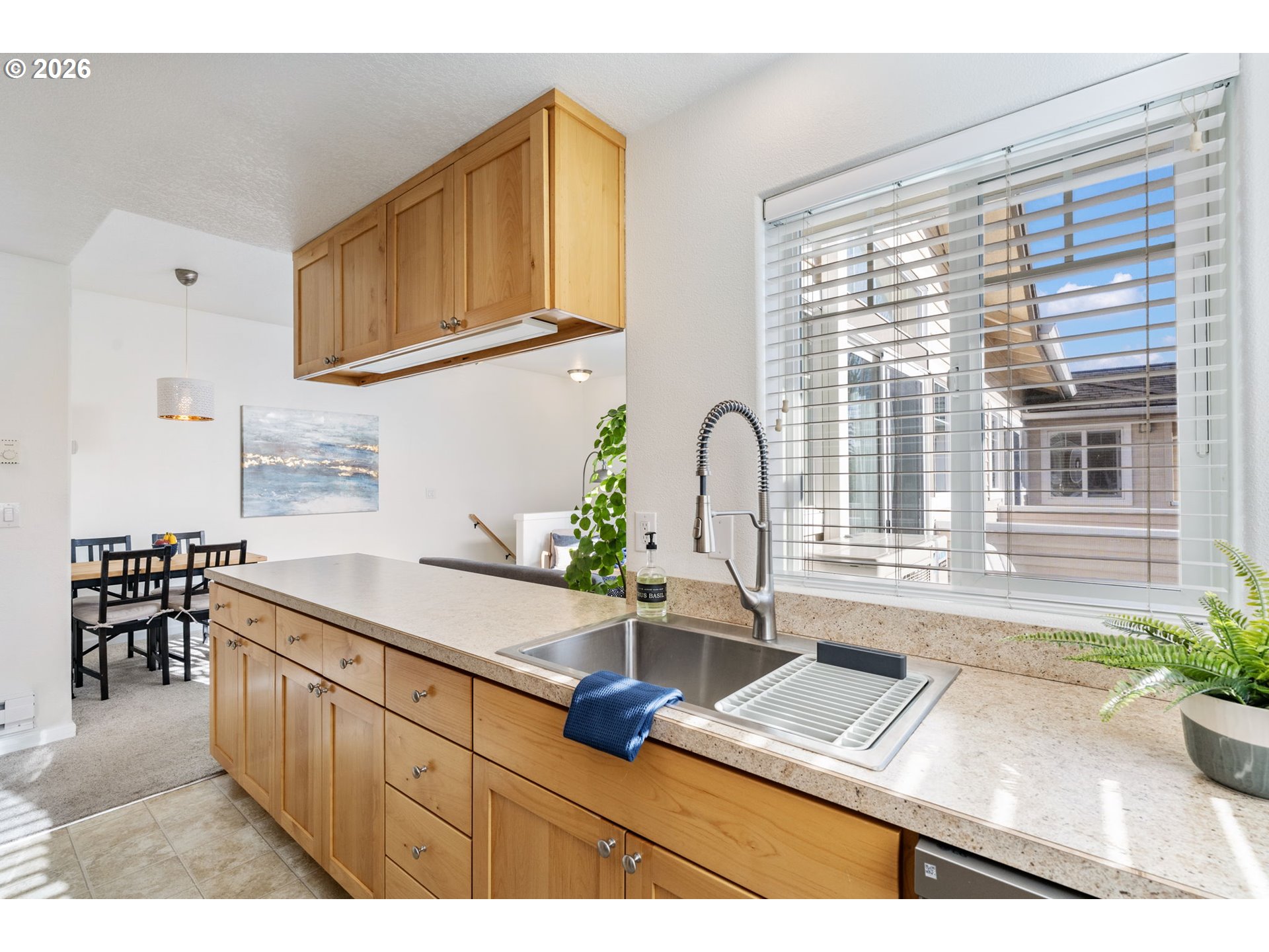 14705 Southwest Sandhill Loop, Unit 202 Beaverton, OR 97007 - Photo 9 of 24 a kitchen with a sink a counter and cabinets