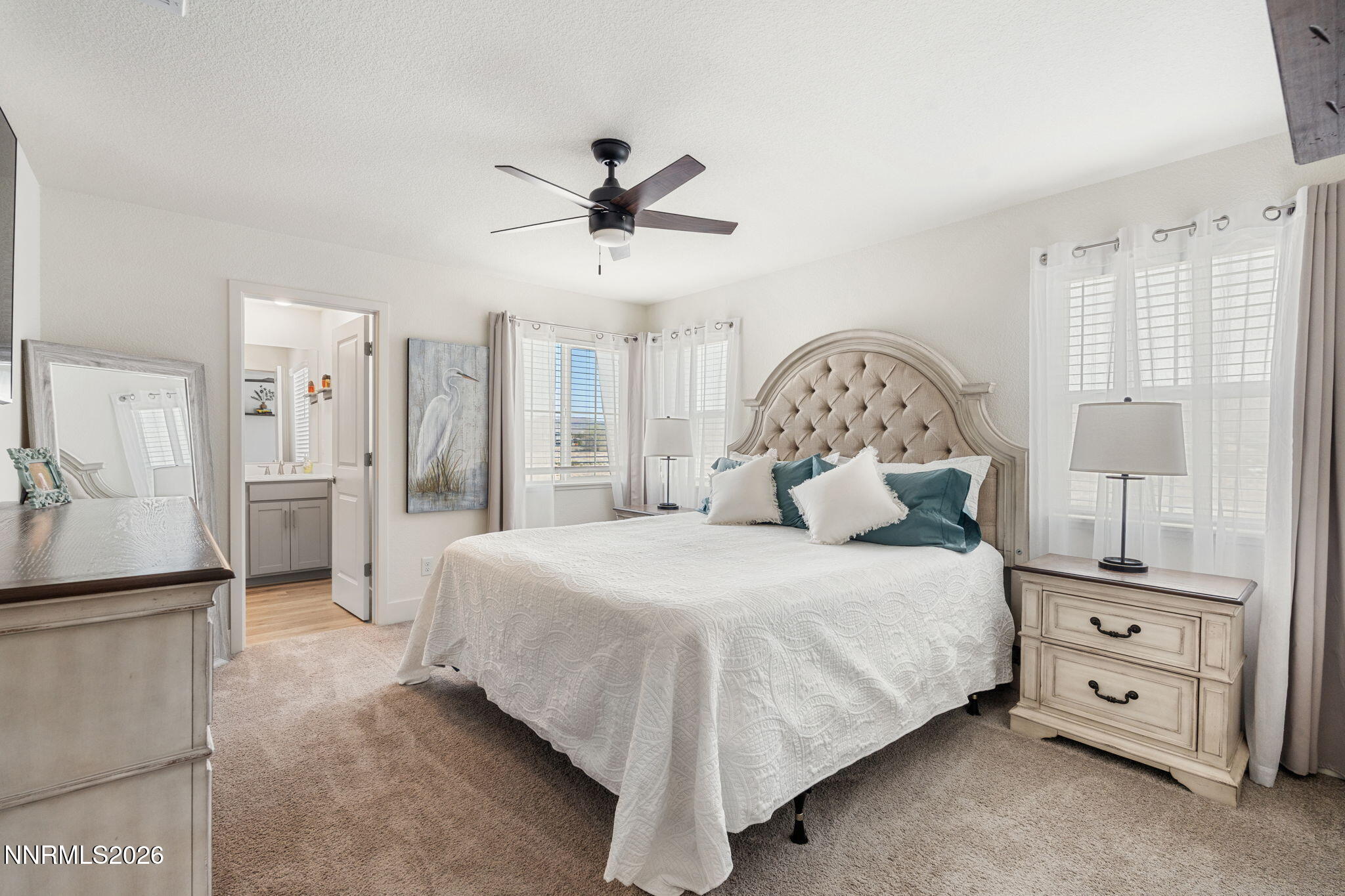 7999 Majorite Way Sparks, NV 89436 - Photo 16 of 26 a bedroom with a large bed and a chandelier