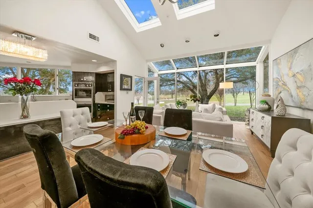 a dining room with furniture and a potted plant