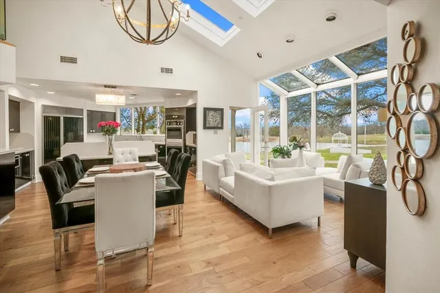 a living room with furniture a flat screen tv and a floor to ceiling window