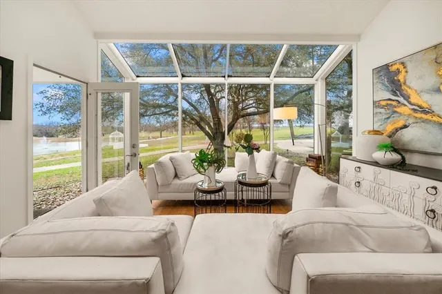 a living room with furniture and large windows
