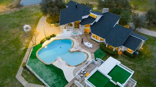 an aerial view of a house with garden space and street view