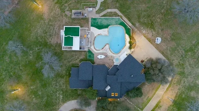 an aerial view of a house with a swimming pool
