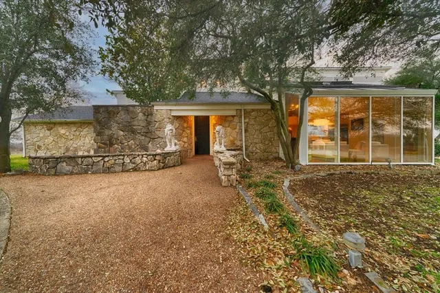 front view of a house with a large tree