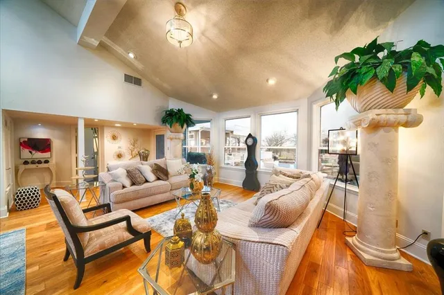 a living room with furniture and a floor to ceiling window