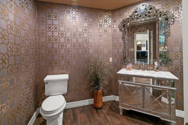 a bathroom with a toilet a sink and mirror