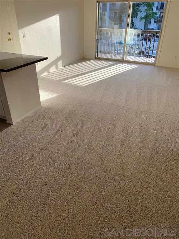 6064 Rancho Mission Road, Unit 448 San Diego, CA 92108 - Photo 11 of 15 a view of an empty room with wooden floor