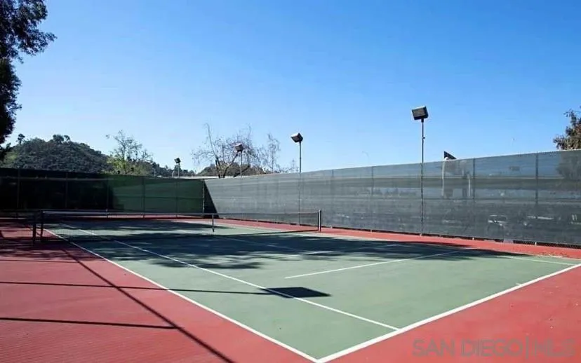 6064 Rancho Mission Road, Unit 448 San Diego, CA 92108 - Photo 15 of 15 a view of a tennis ground with large trees