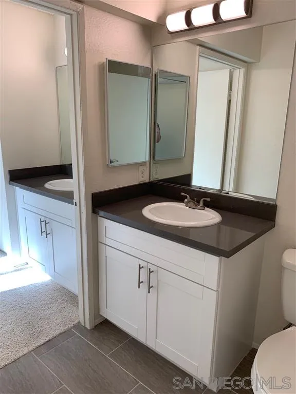 6064 Rancho Mission Road, Unit 448 San Diego, CA 92108 - Photo 6 of 15 a bathroom with a sink and a mirror