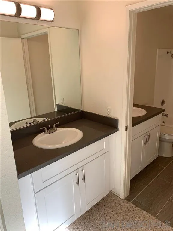 6064 Rancho Mission Road, Unit 448 San Diego, CA 92108 - Photo 9 of 15 a bathroom with a sink and a mirror