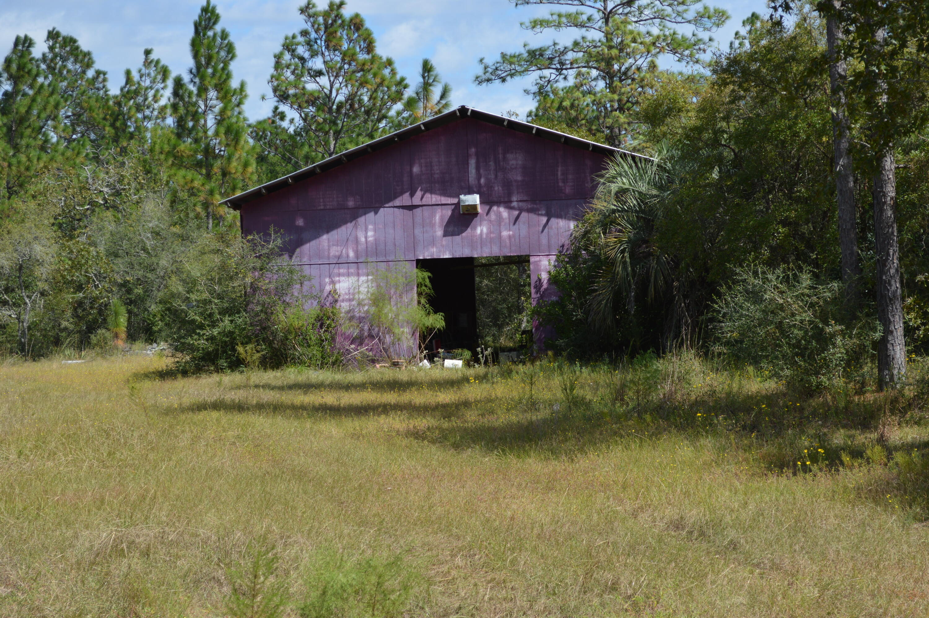 902 Bailie Road Crestview, FL 32539 - Photo 23 of 34 a view of a wooden house with a yard