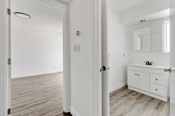 a view of a kitchen with wooden floor