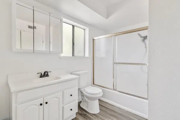 a bathroom with a sink toilet and shower