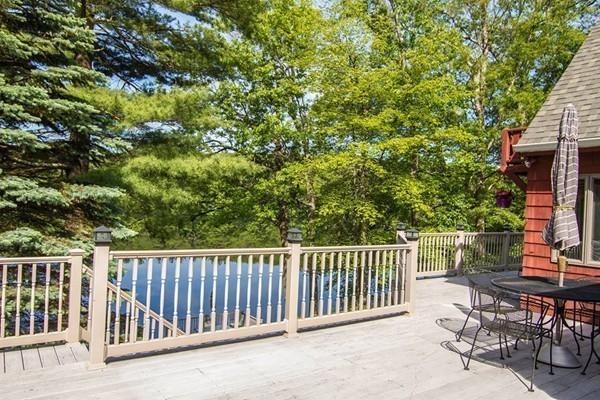 131 Shore Road Sturbridge, MA 01566 - Photo 7 of 29 a balcony with table and chairs and potted plants with wooden floor and fence