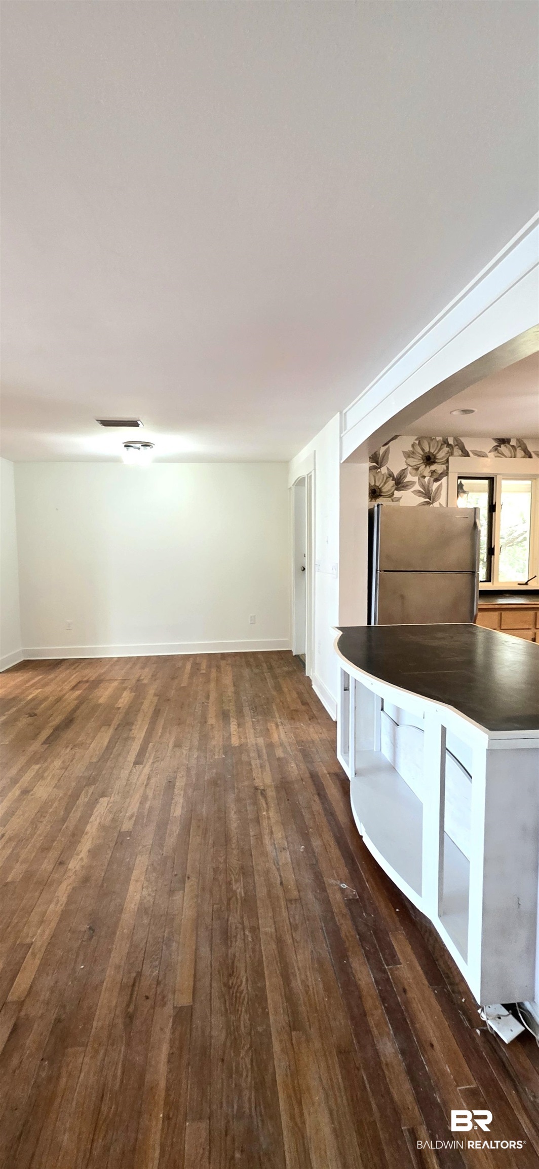 544 Windmill Ridge Road Gulf Shores, AL 36542 - Photo 25 of 50 Unfurnished living room with dark wood-style flooring and baseboards