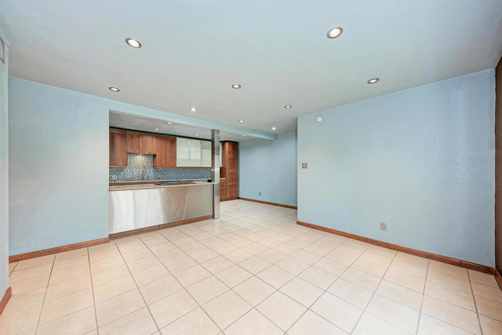 8210 Bent Tree Road, Unit 138 Austin, TX 78759 - Photo 23 of 23 Kitchen with tasteful backsplash, recessed lighting, wood finish cabinetry, and open floor plan