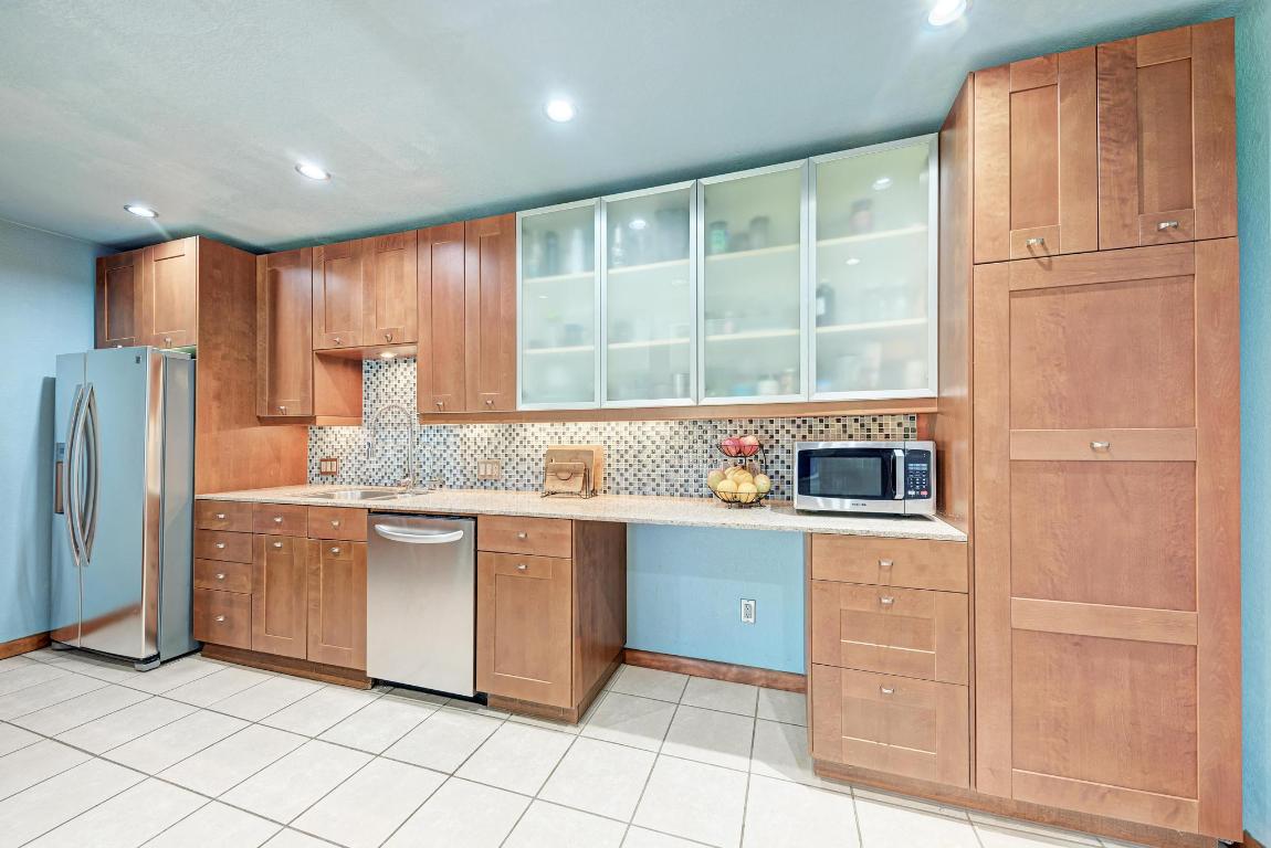 8210 Bent Tree Road, Unit 138 Austin, TX 78759 - Photo 14 of 24 a kitchen with stainless steel appliances granite countertop a refrigerator and a sink
