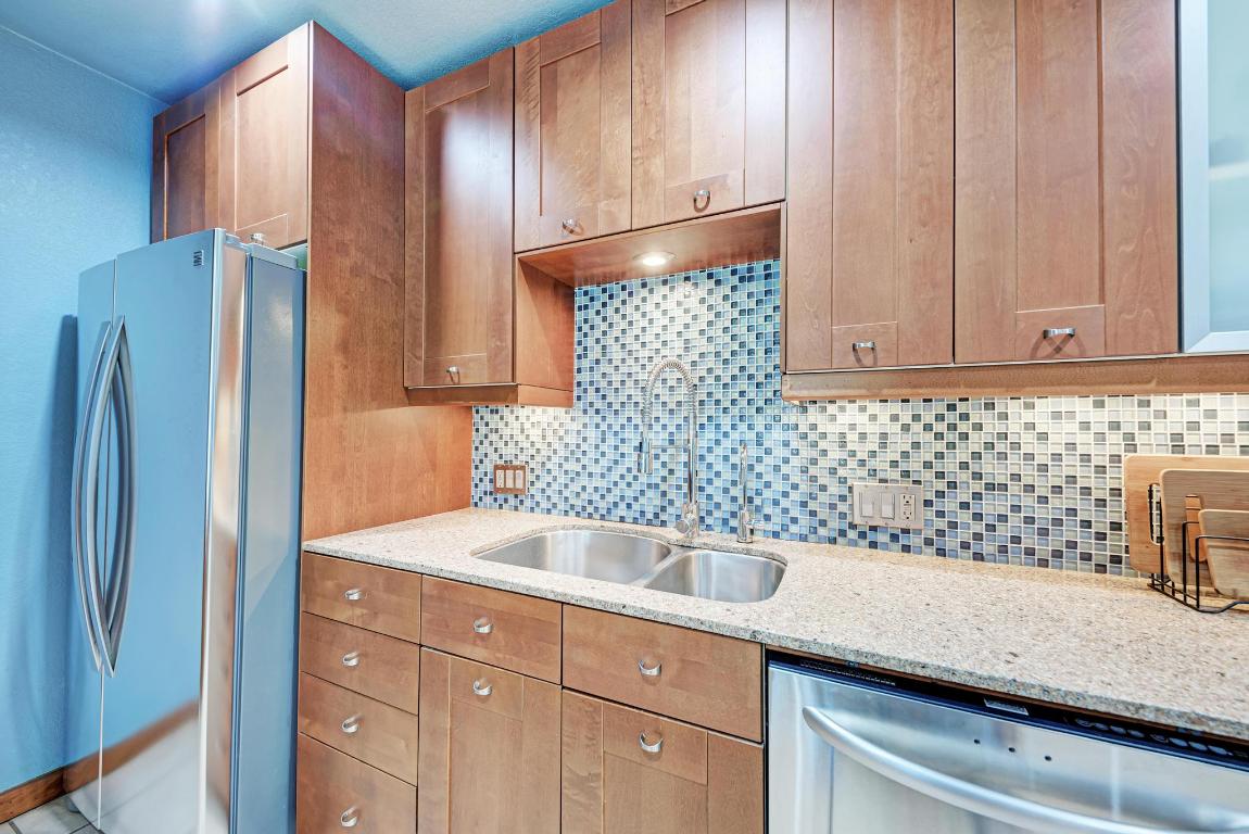 8210 Bent Tree Road, Unit 138 Austin, TX 78759 - Photo 15 of 24 a kitchen with stainless steel appliances granite countertop a refrigerator and a sink
