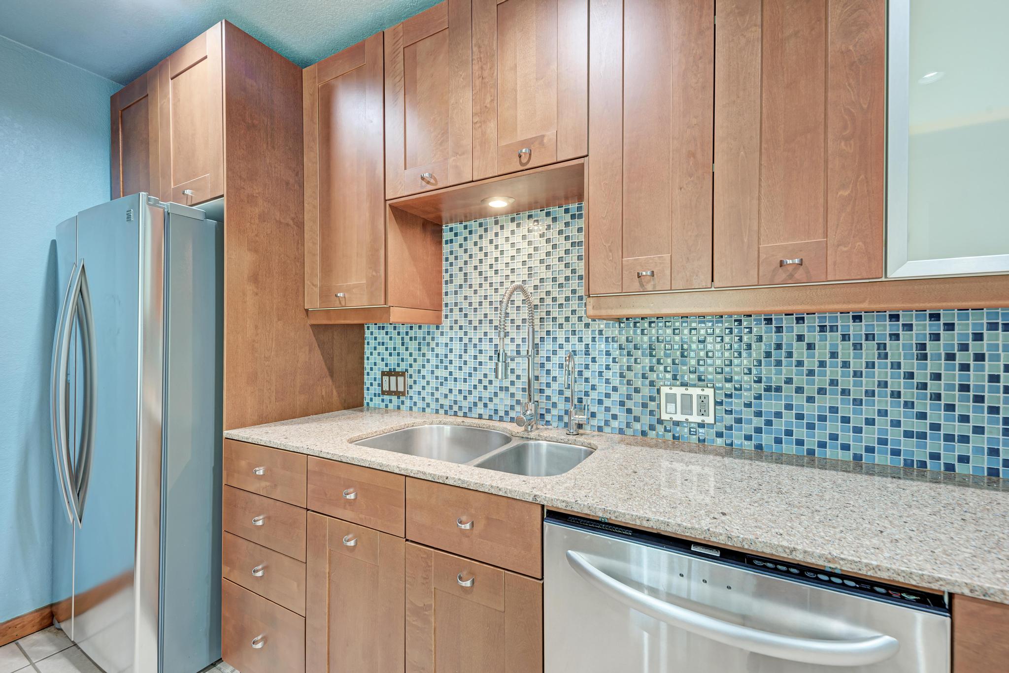 8210 Bent Tree Road, Unit 138 Austin, TX 78759 - Photo 16 of 23 Kitchen featuring stainless steel appliances, light stone counters, backsplash, and light tile patterned floors
