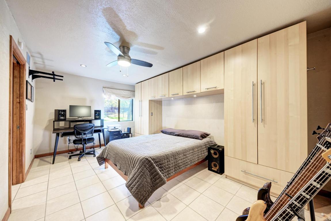 8210 Bent Tree Road, Unit 138 Austin, TX 78759 - Photo 16 of 24 a bedroom with a bed and a table with closet