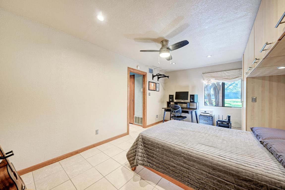 8210 Bent Tree Road, Unit 138 Austin, TX 78759 - Photo 17 of 24 a bedroom with a large bed and a large mirror