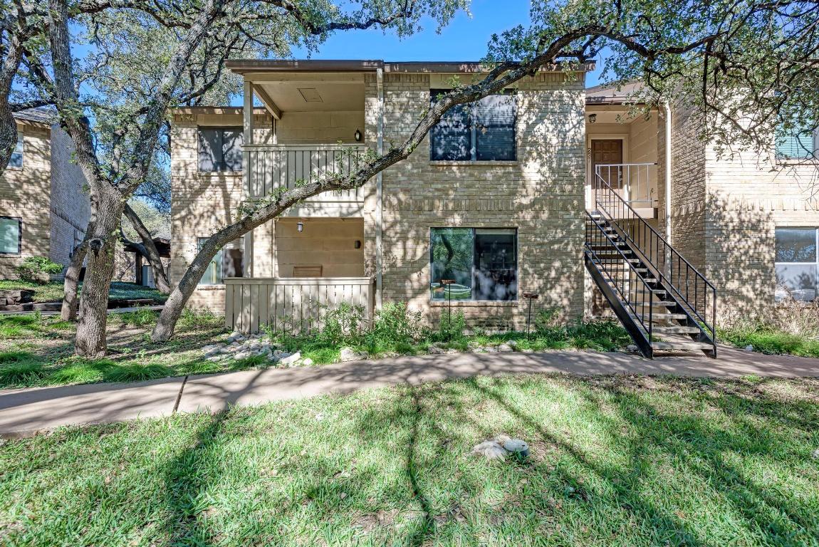 8210 Bent Tree Road, Unit 138 Austin, TX 78759 - Photo 2 of 24 front view of a house with a yard