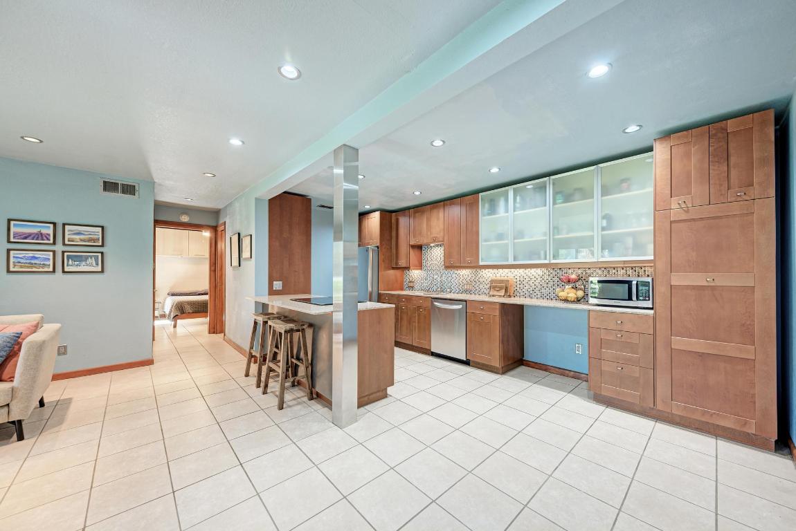 8210 Bent Tree Road, Unit 138 Austin, TX 78759 - Photo 6 of 24 a kitchen with stainless steel appliances granite countertop a refrigerator and a stove top oven