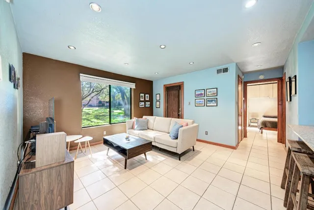 a living room with furniture and a large window