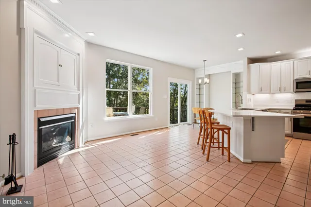 a kitchen with stainless steel appliances white cabinets and a refrigerator