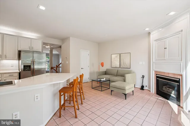 a kitchen with white cabinets and a refrigerator