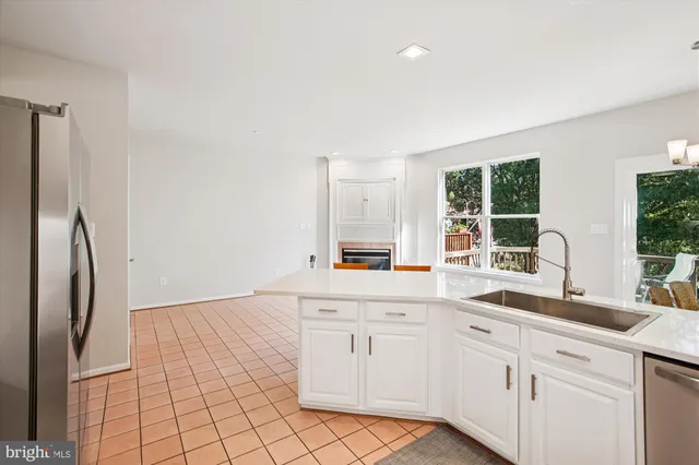 a white bath tub sitting in a bathroom next to a window