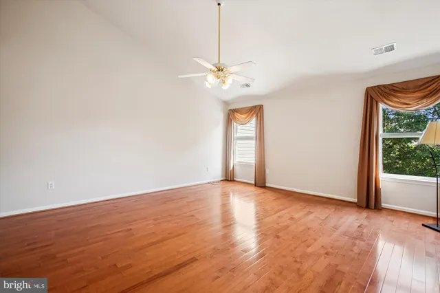 a view of an empty room with window and cabinet
