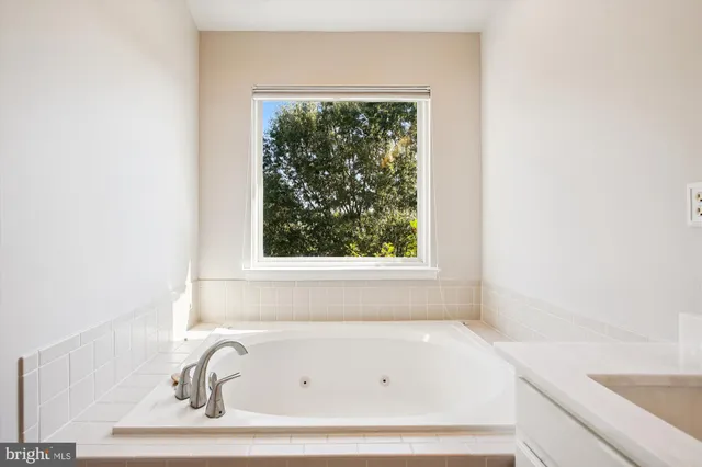 a bathroom with a granite countertop sink a toilet and a bathtub