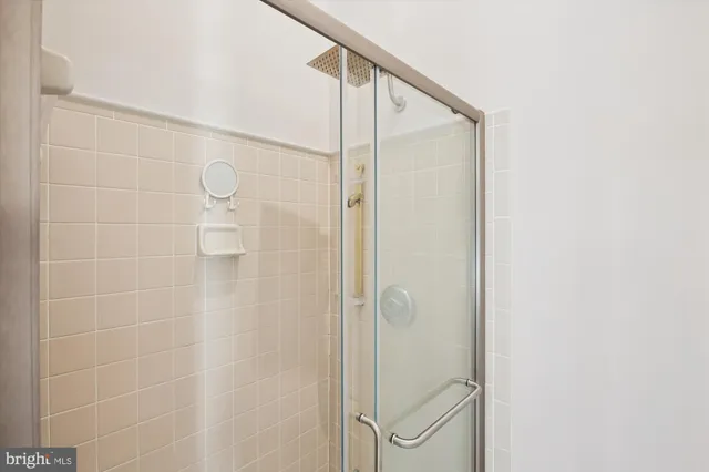 a bathroom with a bath tub with a shower