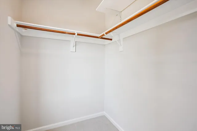 a living room with granite countertop kitchen view and a wooden floor