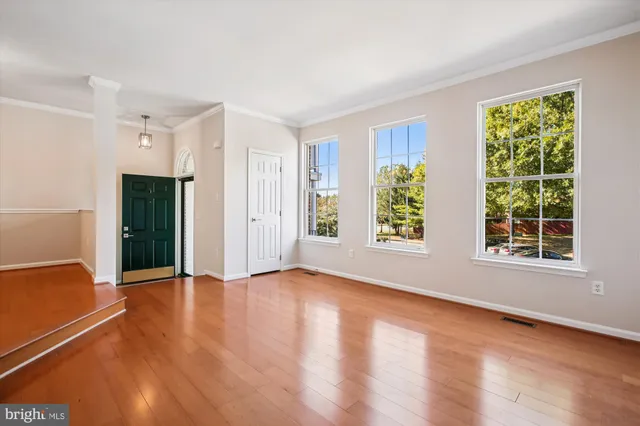 a living room with furniture and a table with wooden floor