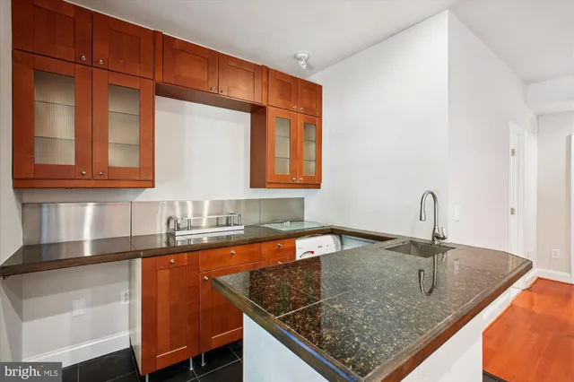 a view of a patio with table and chairs with wooden floor and fence