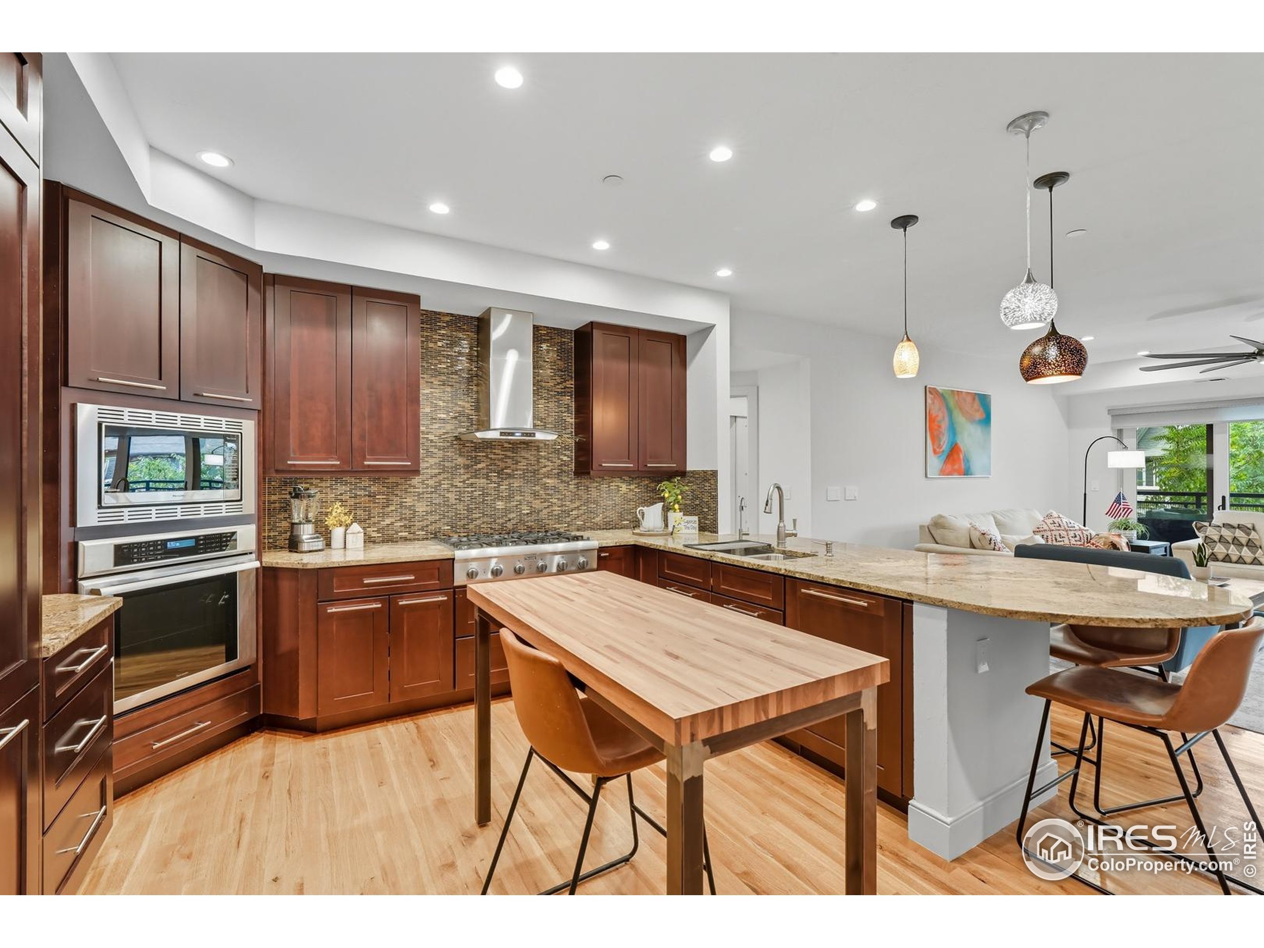 2801 Pennsylvania Avenue, Unit 203 Boulder, CO 80303 - Photo 12 of 50 a kitchen with stainless steel appliances granite countertop wooden cabinets a stove a sink and a refrigerator