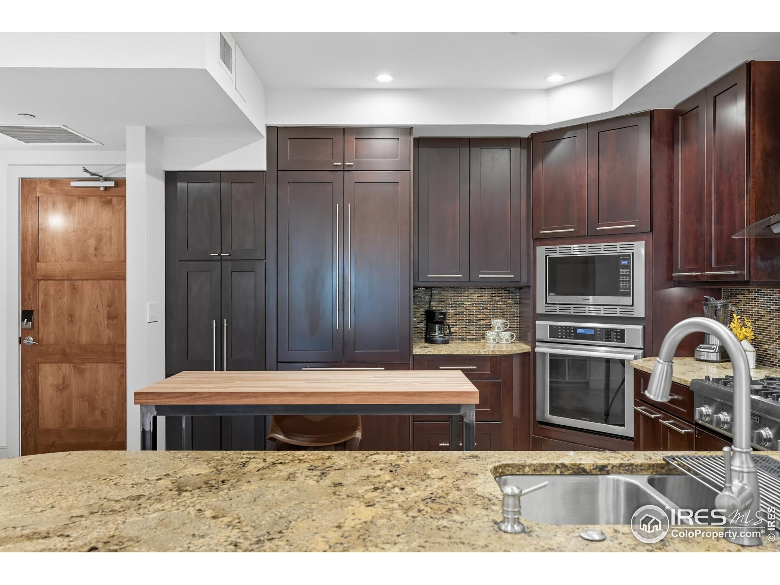 2801 Pennsylvania Avenue, Unit 203 Boulder, CO 80303 - Photo 13 of 50 a kitchen with a refrigerator stove and cabinets